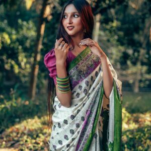 Beautiful Bengali woman in traditional saree posing in lush outdoor setting in Comilla, Bangladesh.